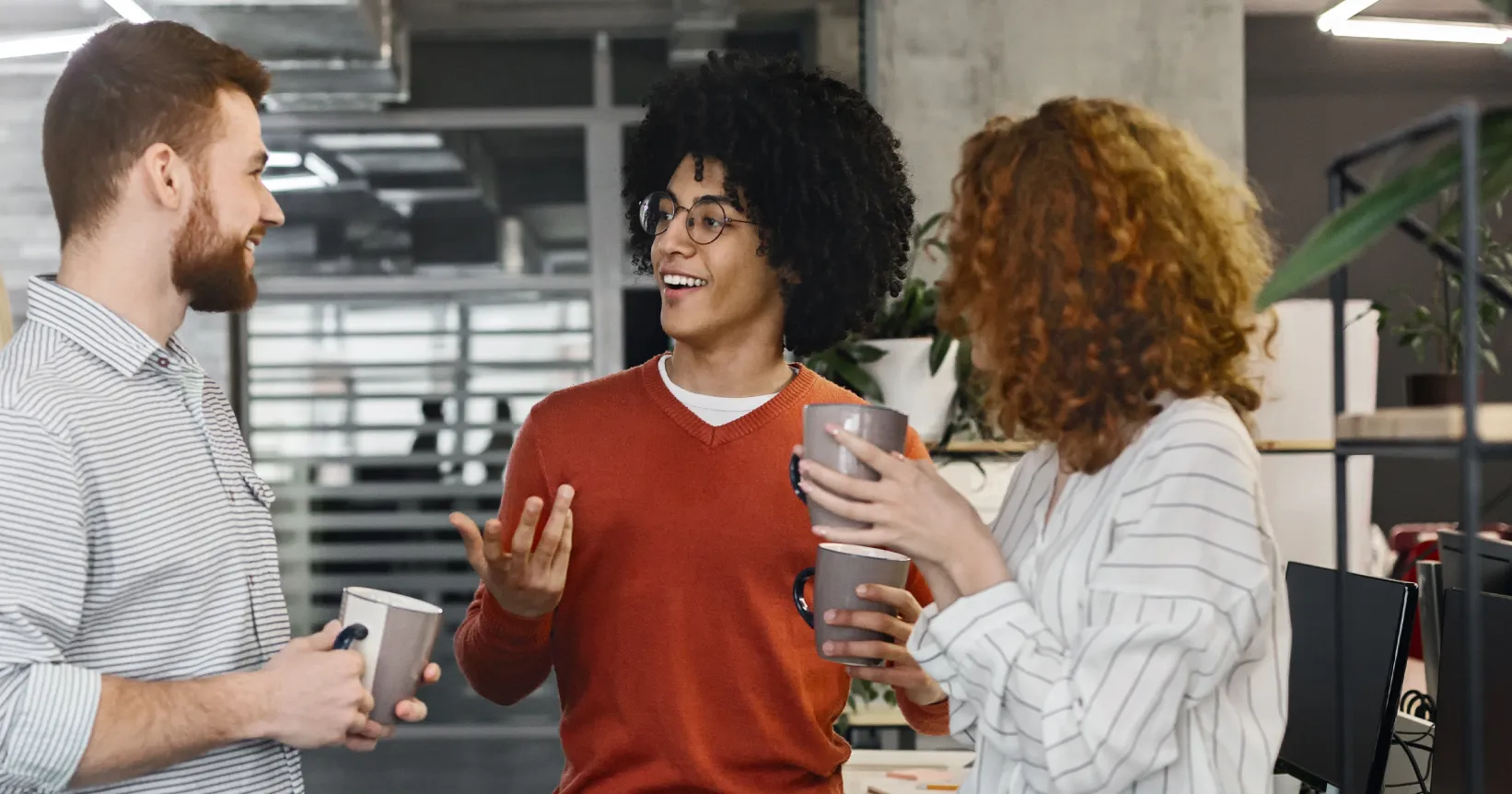 Un groupe de collègues discutent ensemble à une pause-café