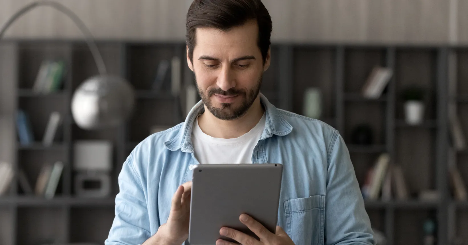Un homme manipule une tablette électronique