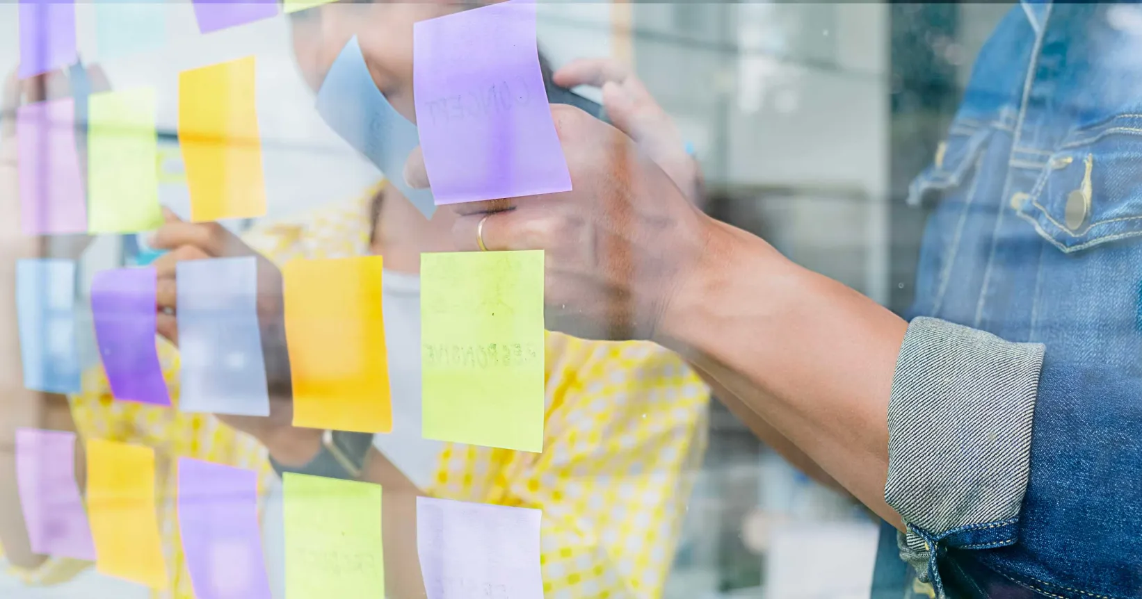 Quelqu'un pose des post-it sur une fenêtre