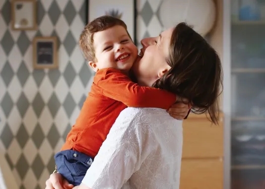 Adult holding a young child in their arms