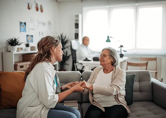 Infirmière tenant les mains d'une dame