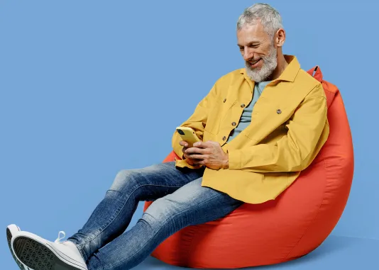 Person seated, looking at a mobile device